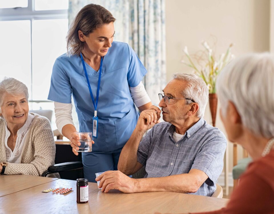 nurse-helping-senior-man-to-take-his-daily-medicine